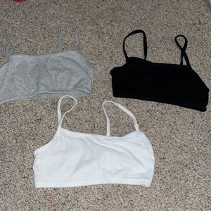 Three different started bras in a set of white, grey, and black